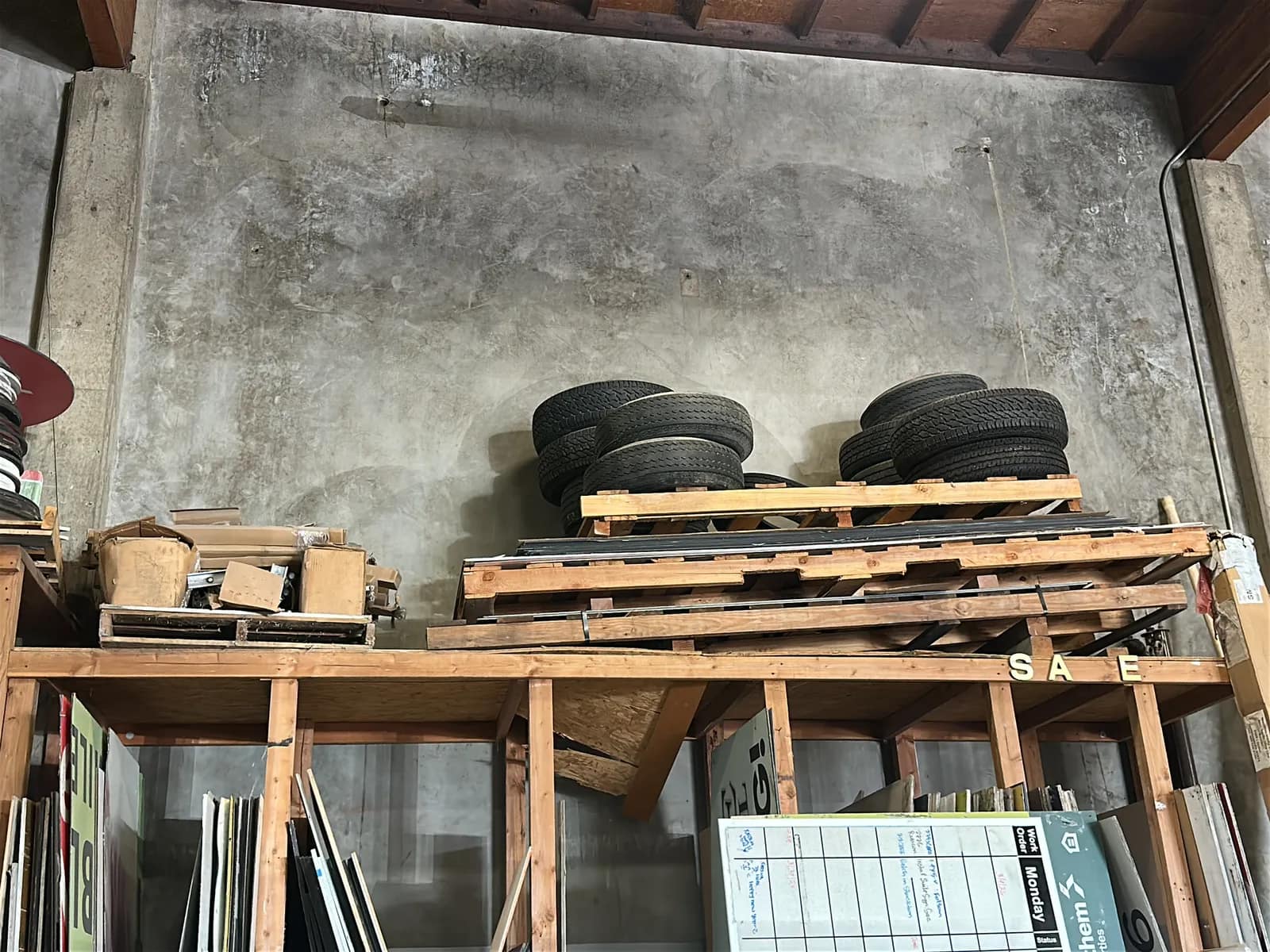 contents-of-shelf-11-assorted-tires-and-pallet-of-sign-holding-items-3d8dd1