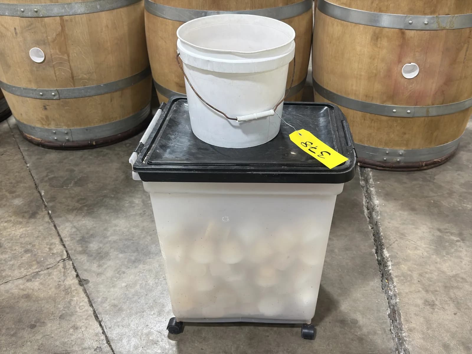 bucket-and-bin-of-wine-barrel-rubber-plugs-f58349