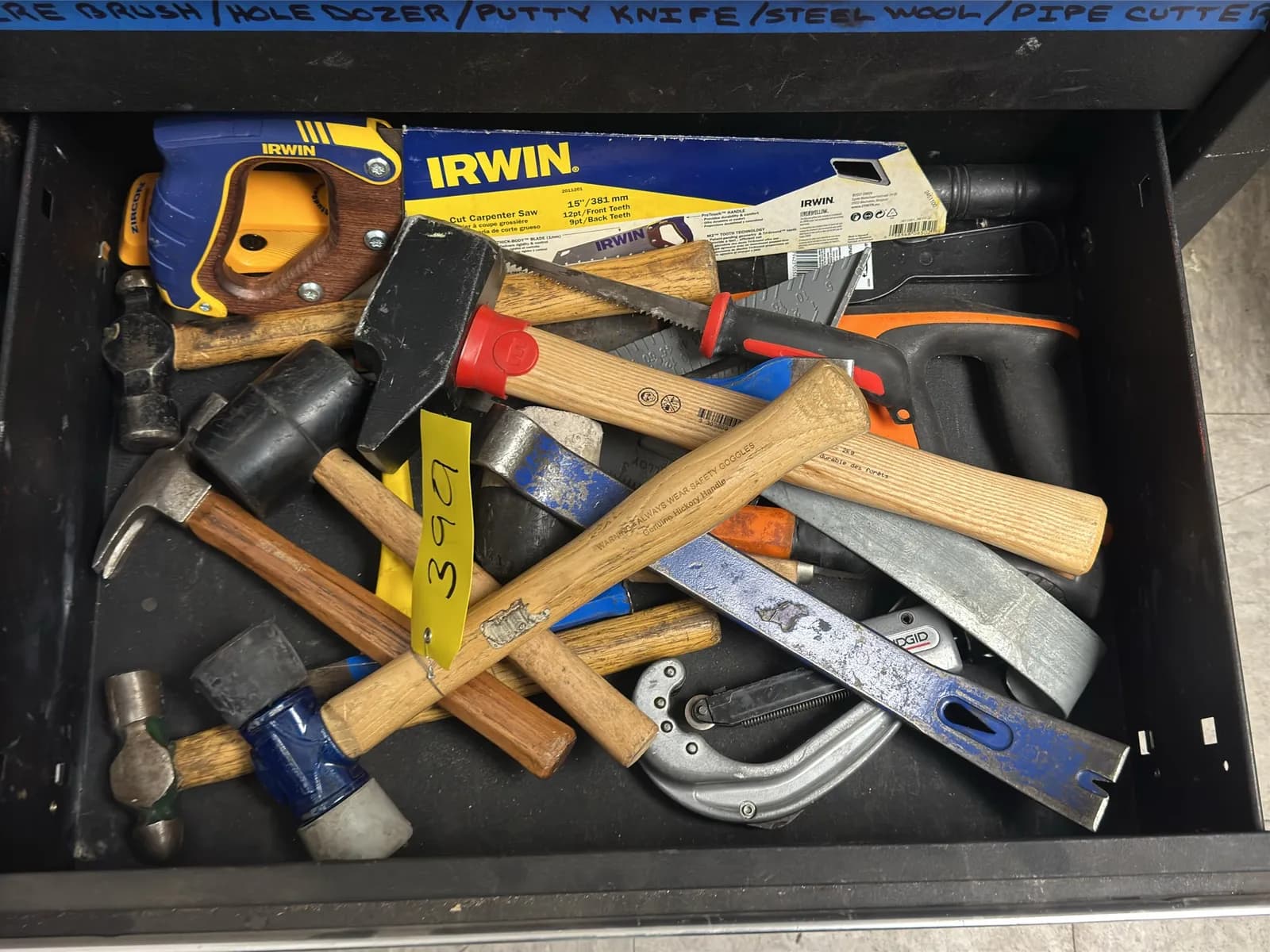 contents-of-drawer-rubber-mallet-crow-bar-carpenter-saw-and-more-b54b76