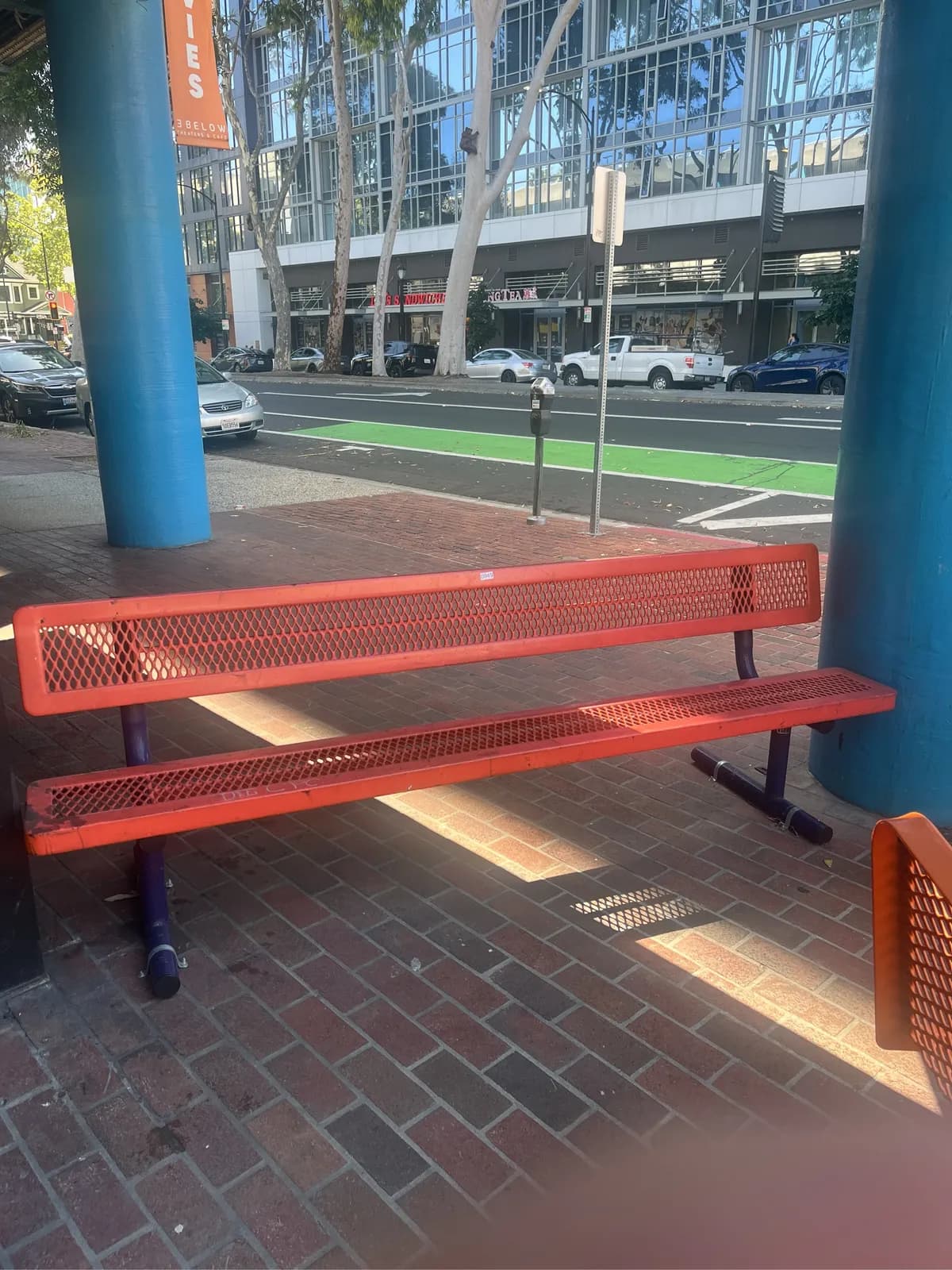 orange-metal-bench-with-seat-and-back-and-purple-legs-mpmra7bq