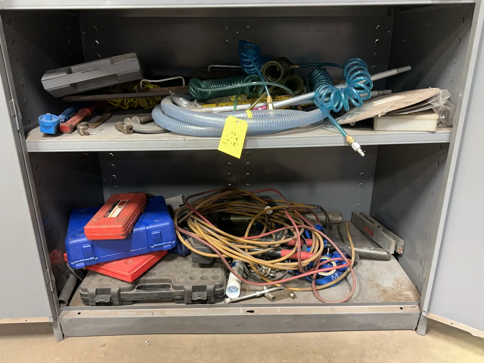 contents-of-2-shelves-pneumatic-hoses-air-guns-empty-tool-cases-assorted-extension-cords-and-more-mrdq4mc8